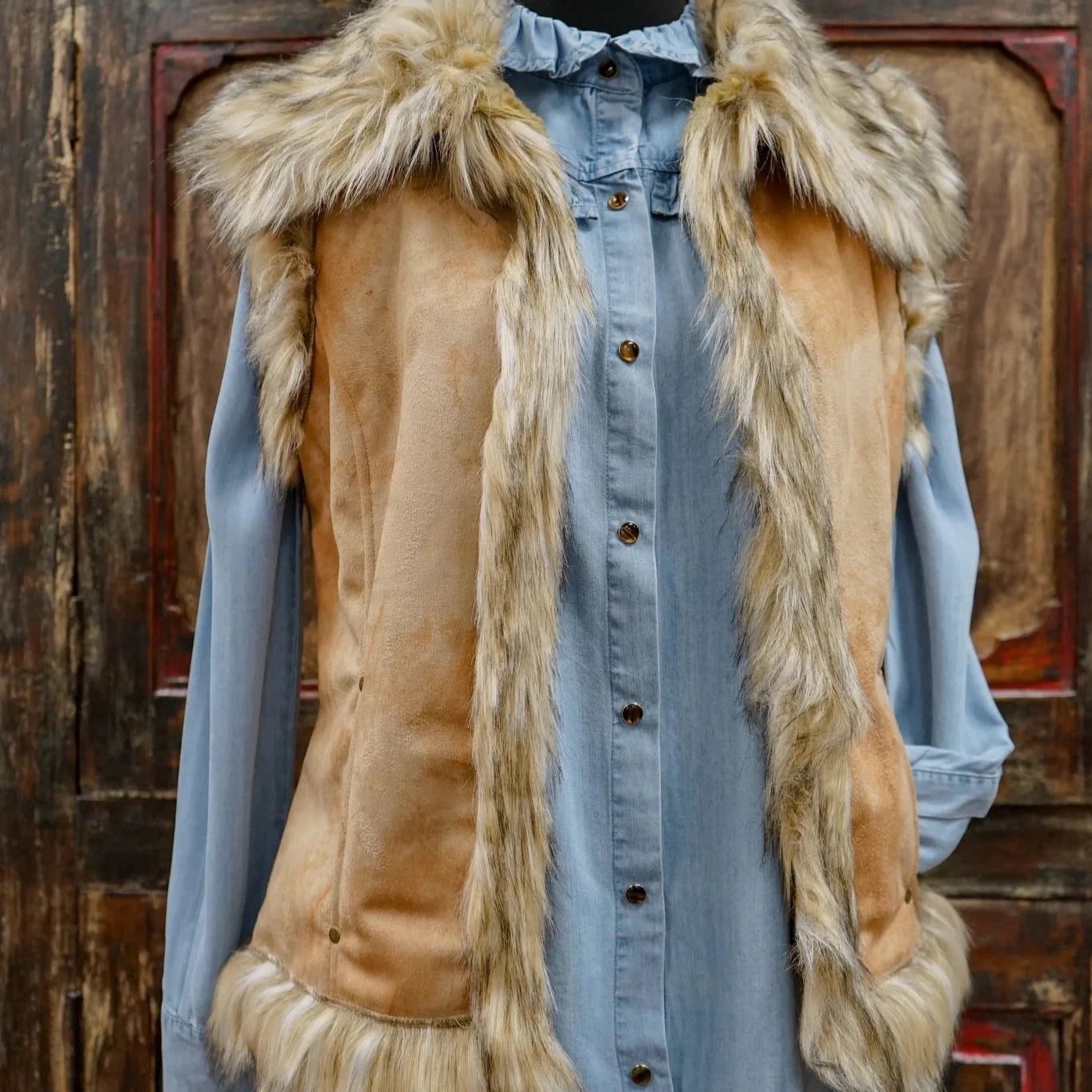 Fur vest over denim shirt