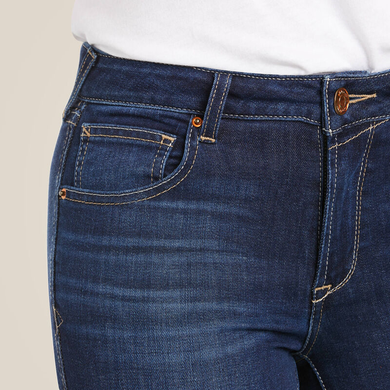 Close-up of dark blue denim jeans with pockets.