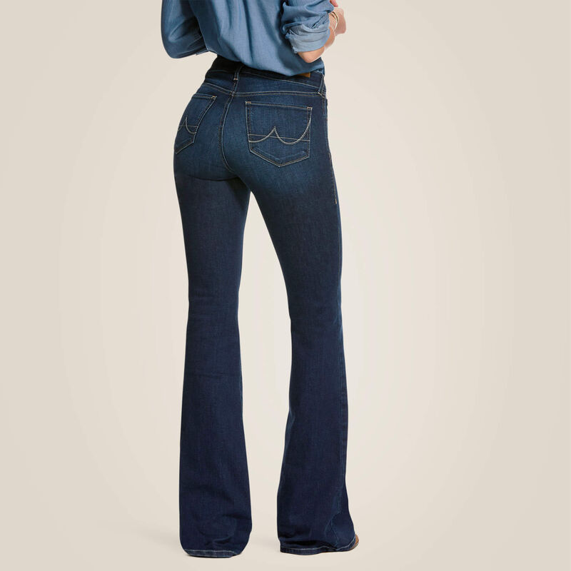 Woman wearing dark blue flared jeans.