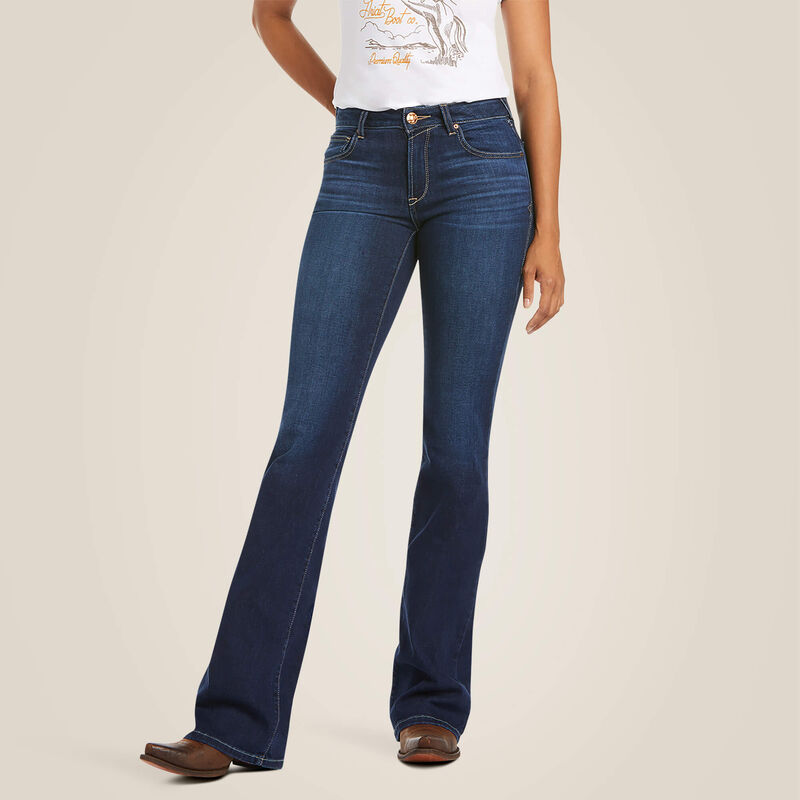 Woman wearing blue flared jeans and a white shirt.