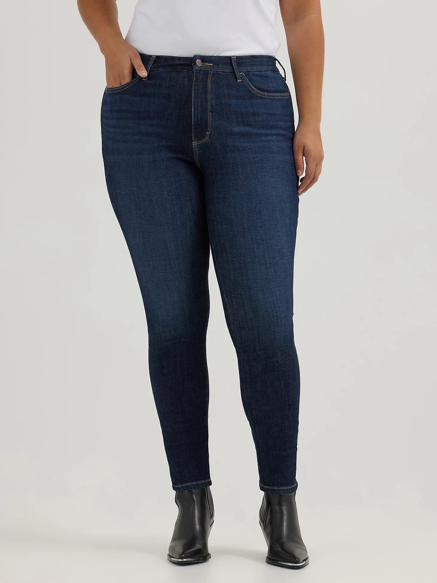 Woman in dark blue jeans and black boots.