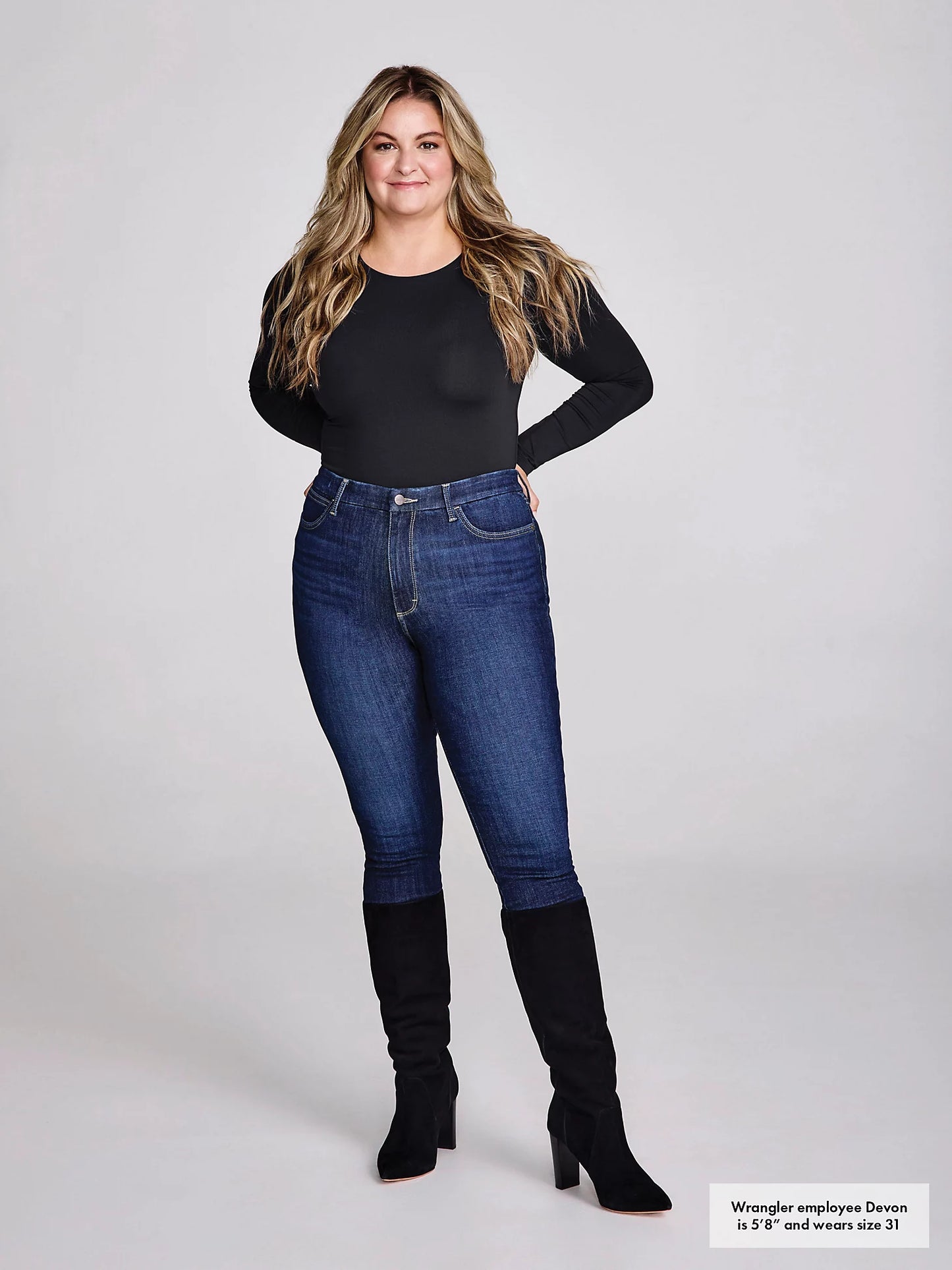 Woman in black shirt, jeans, and boots.