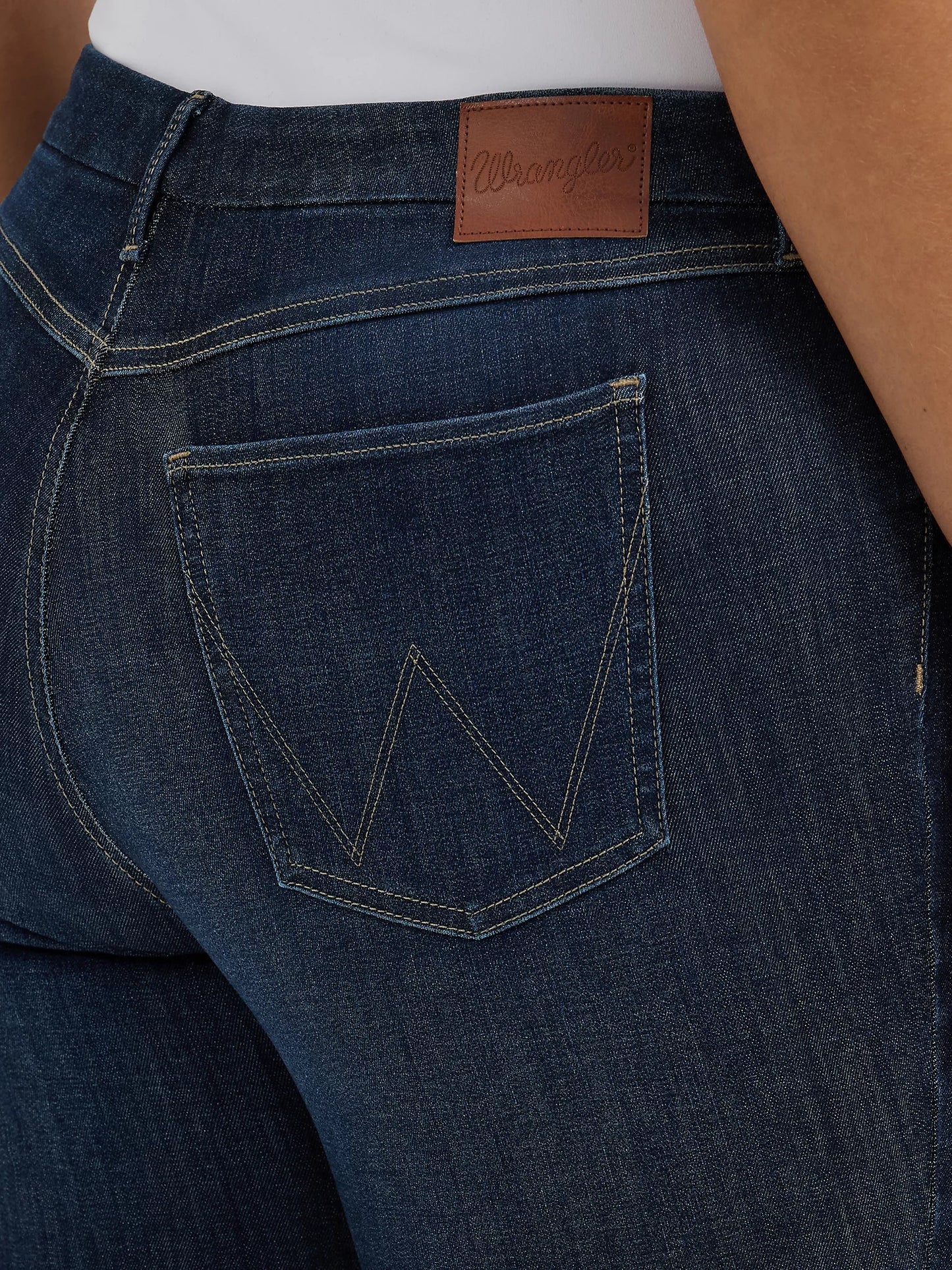 Close-up of dark blue Wrangler jeans with back pocket.