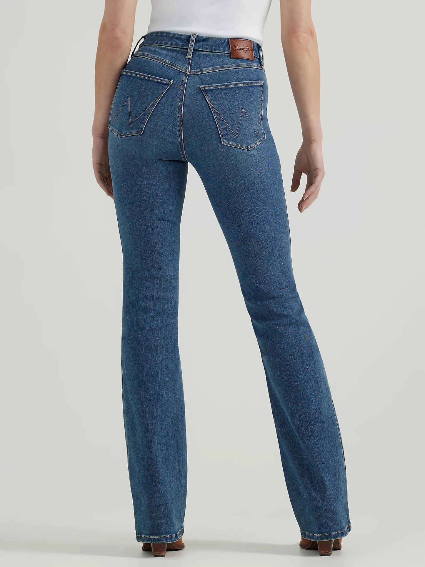 Woman wearing blue denim flared jeans.