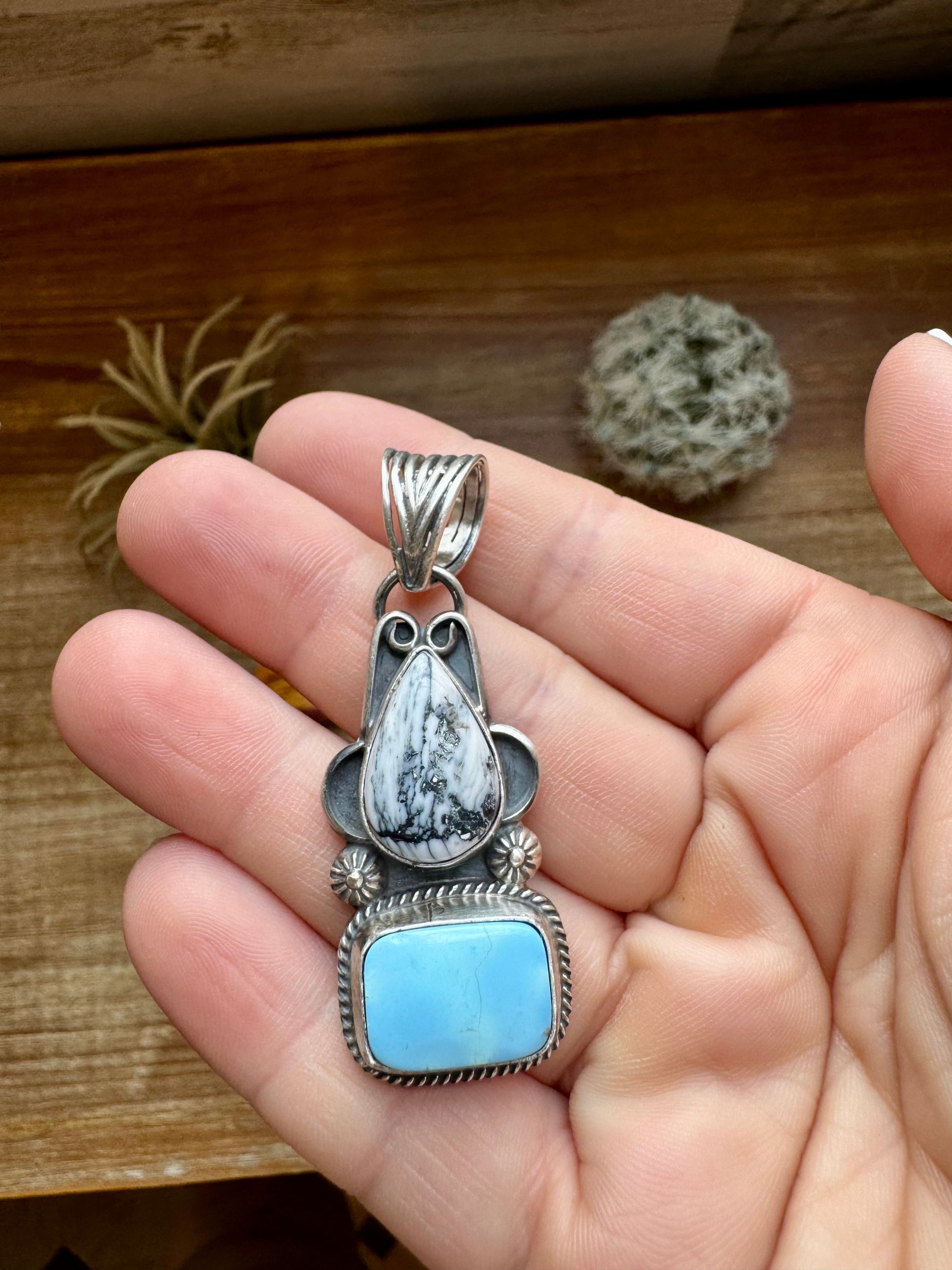 Turquoise & white stone pendant in hand (1602E356-45F7)