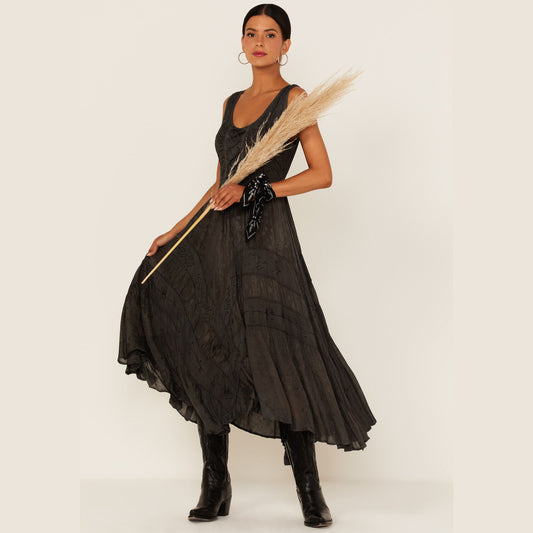 Woman in black dress holding plant.