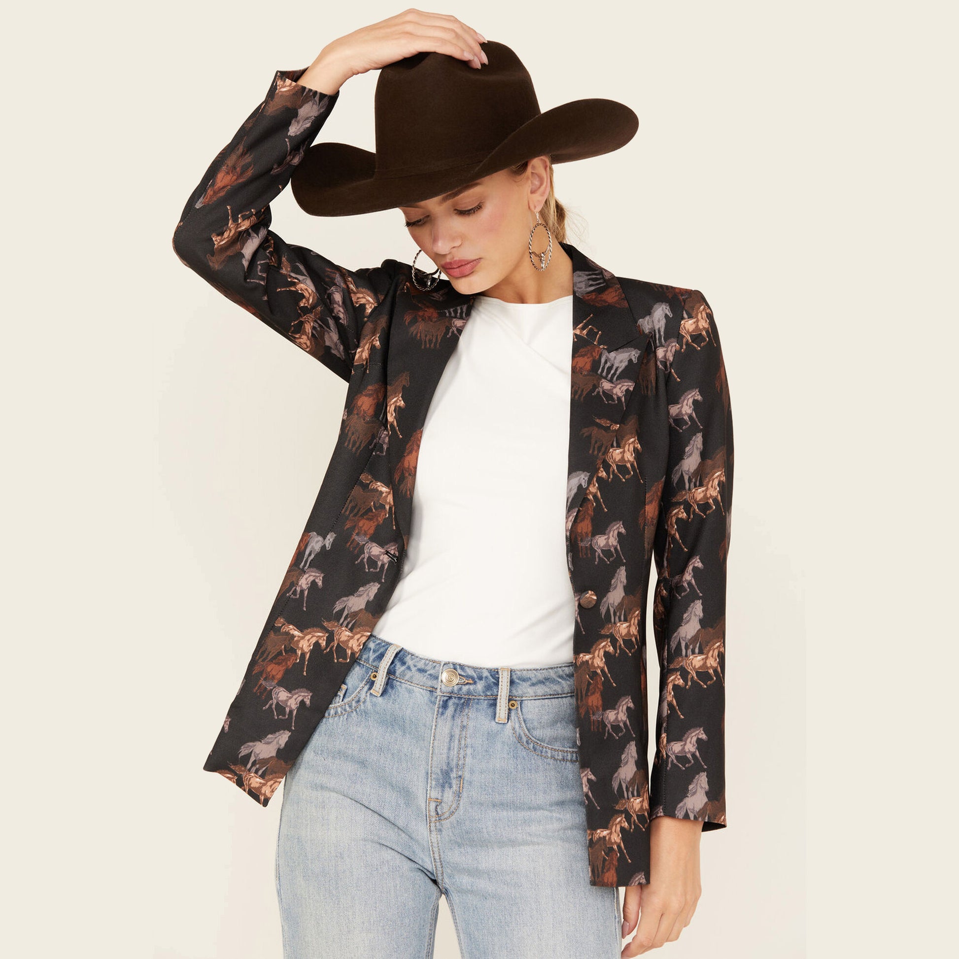 Woman in cowboy hat and horse print blazer.