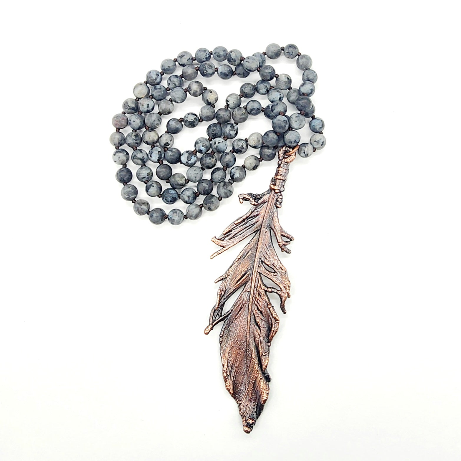 Gray beaded necklace with bronze feather pendant.