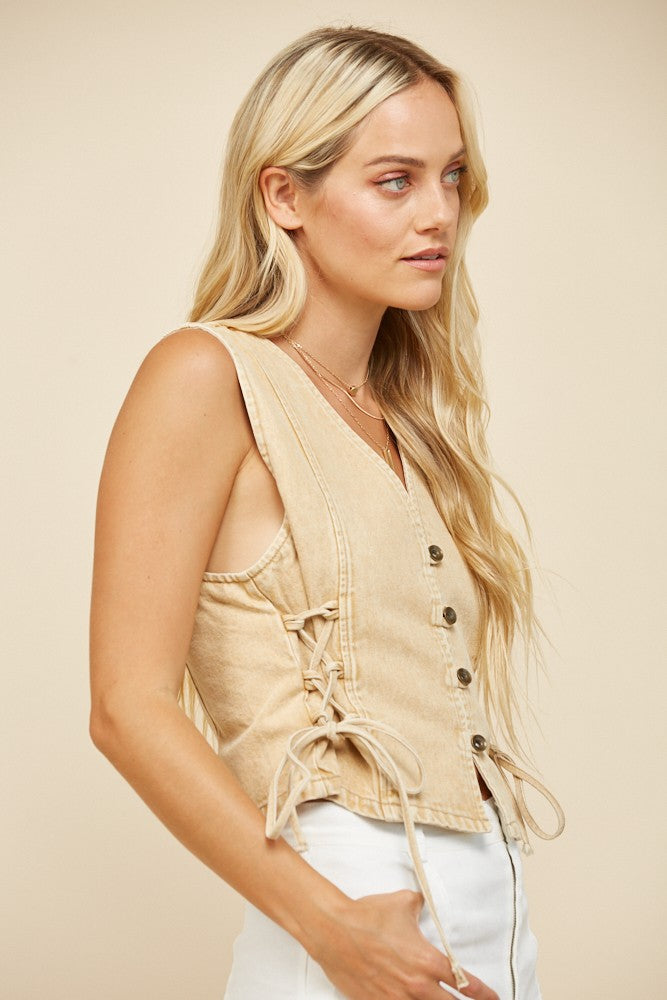 Woman wearing a beige vest.