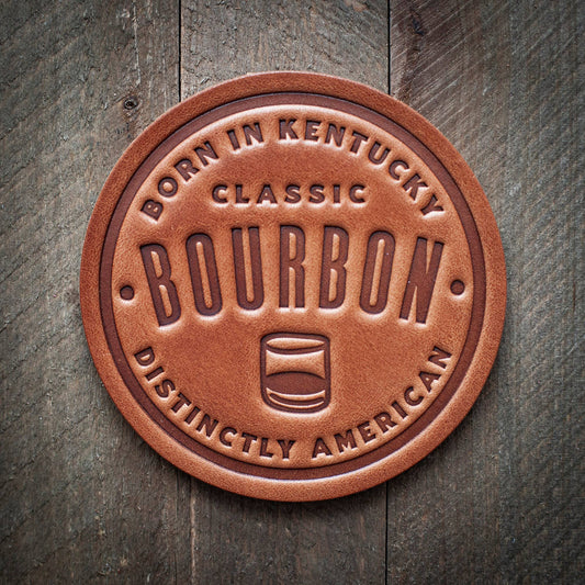 Leather bourbon coaster on wood