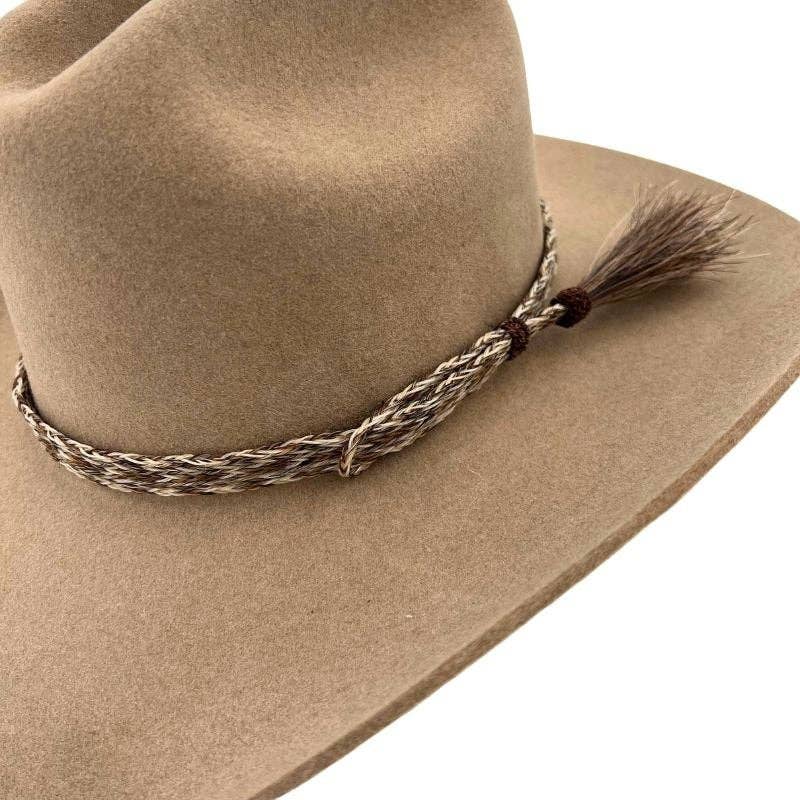 Tan cowboy hat with braided band.
