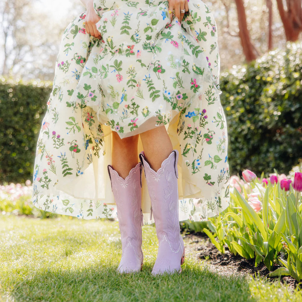 Woman in floral dress and lavender boots
