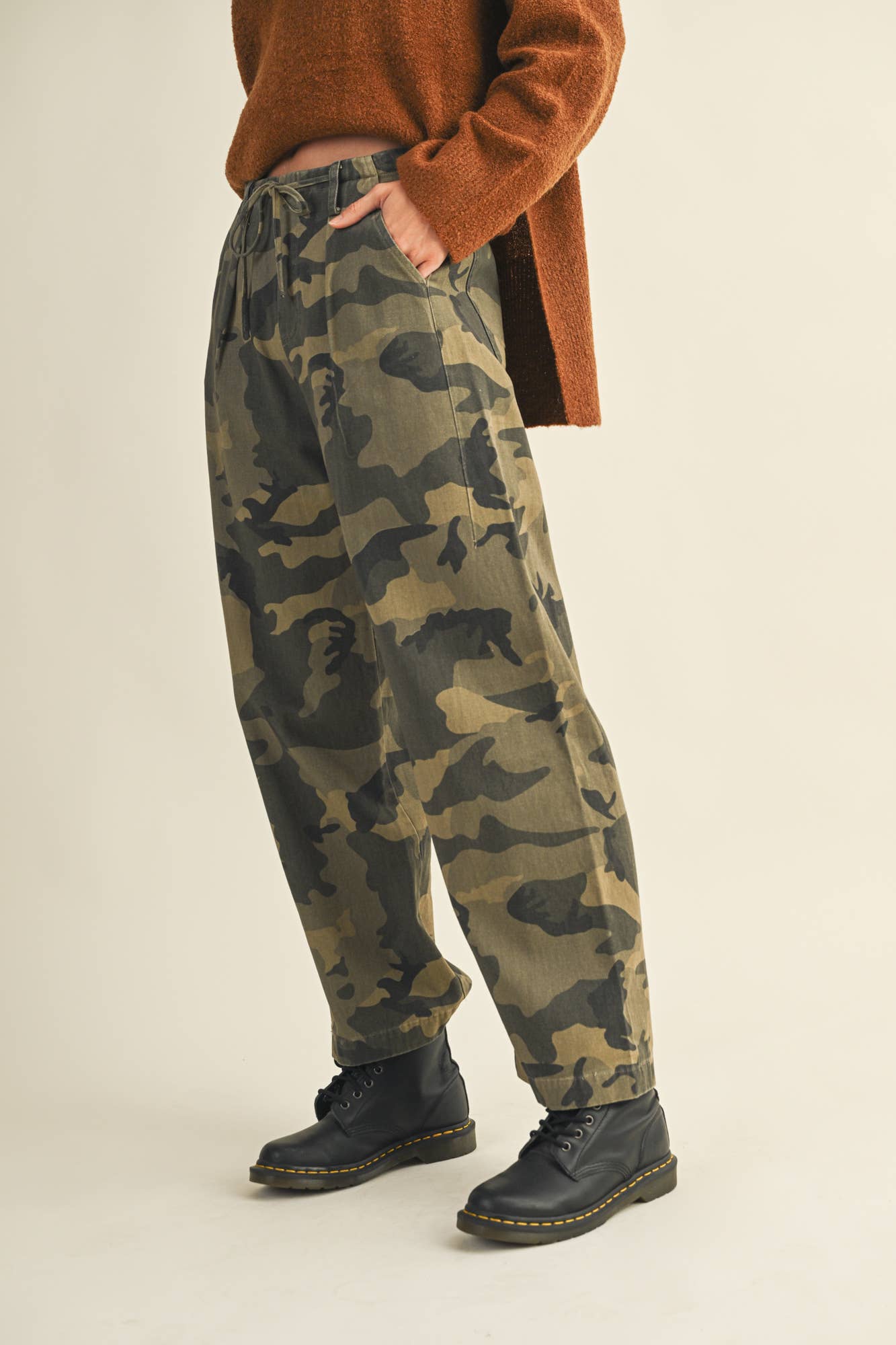 Person wearing camouflage pants and boots.