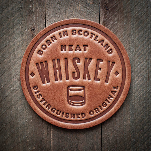 Leather coaster with whiskey text.