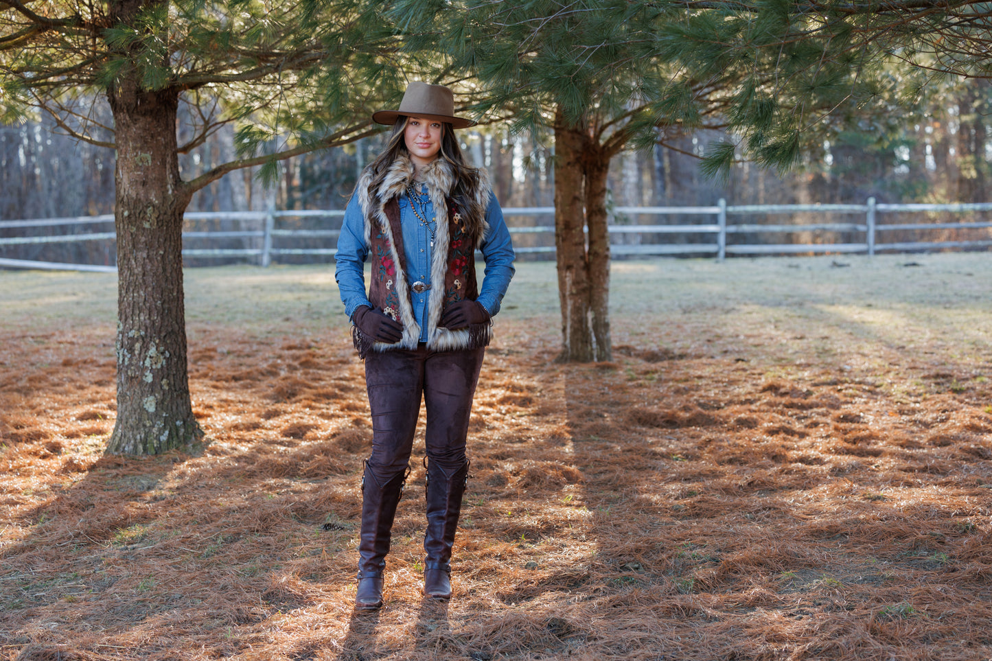Woman in Chateau Vest and hat outdoors.