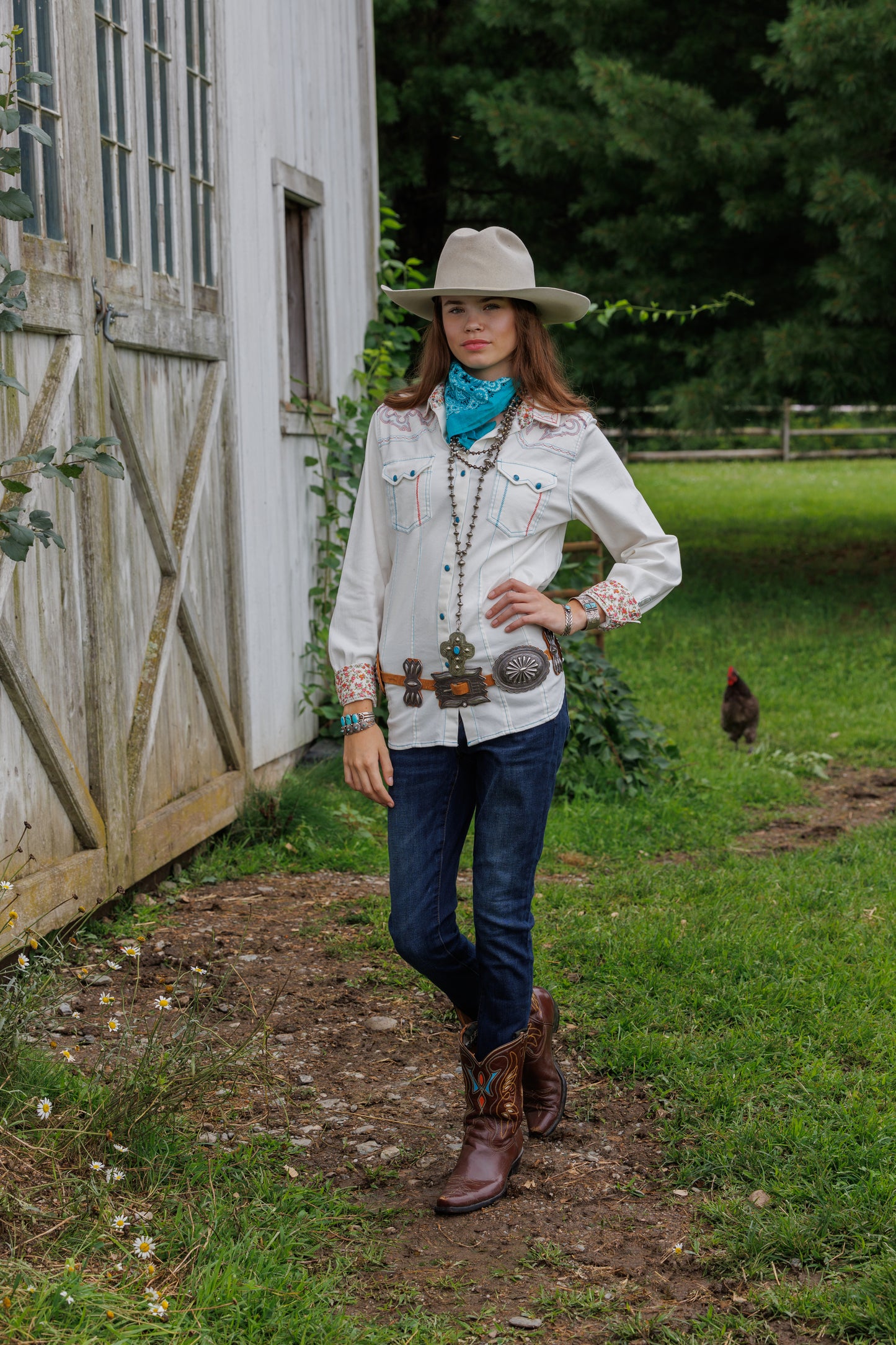 Cowgirl in white shirt, jeans, and cowboy boots.