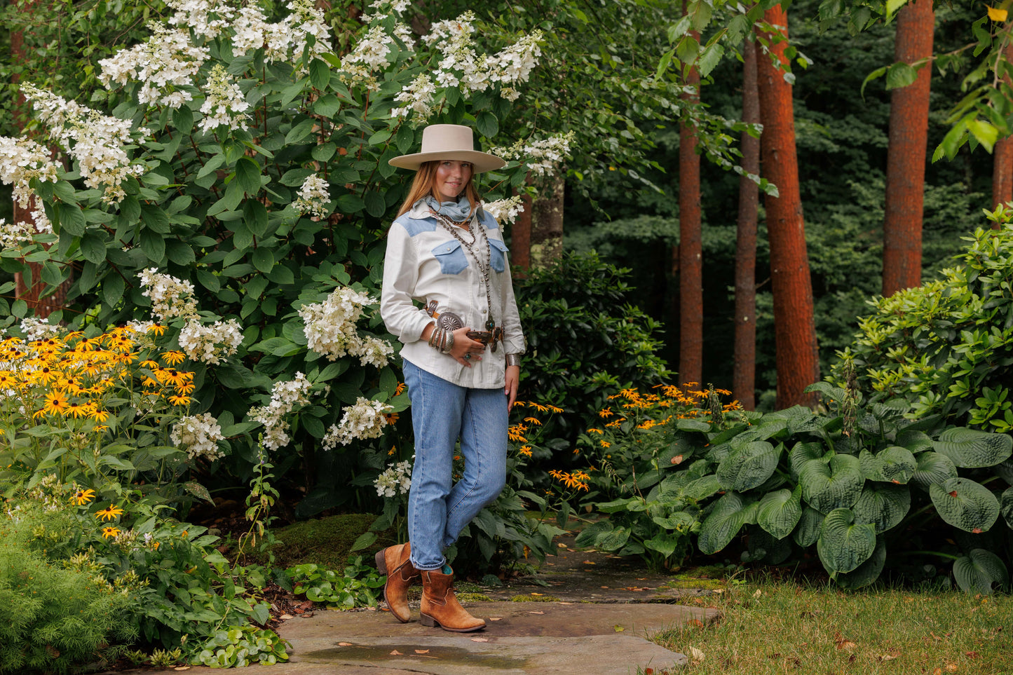 Woman in Virginia shirt and hat in garden