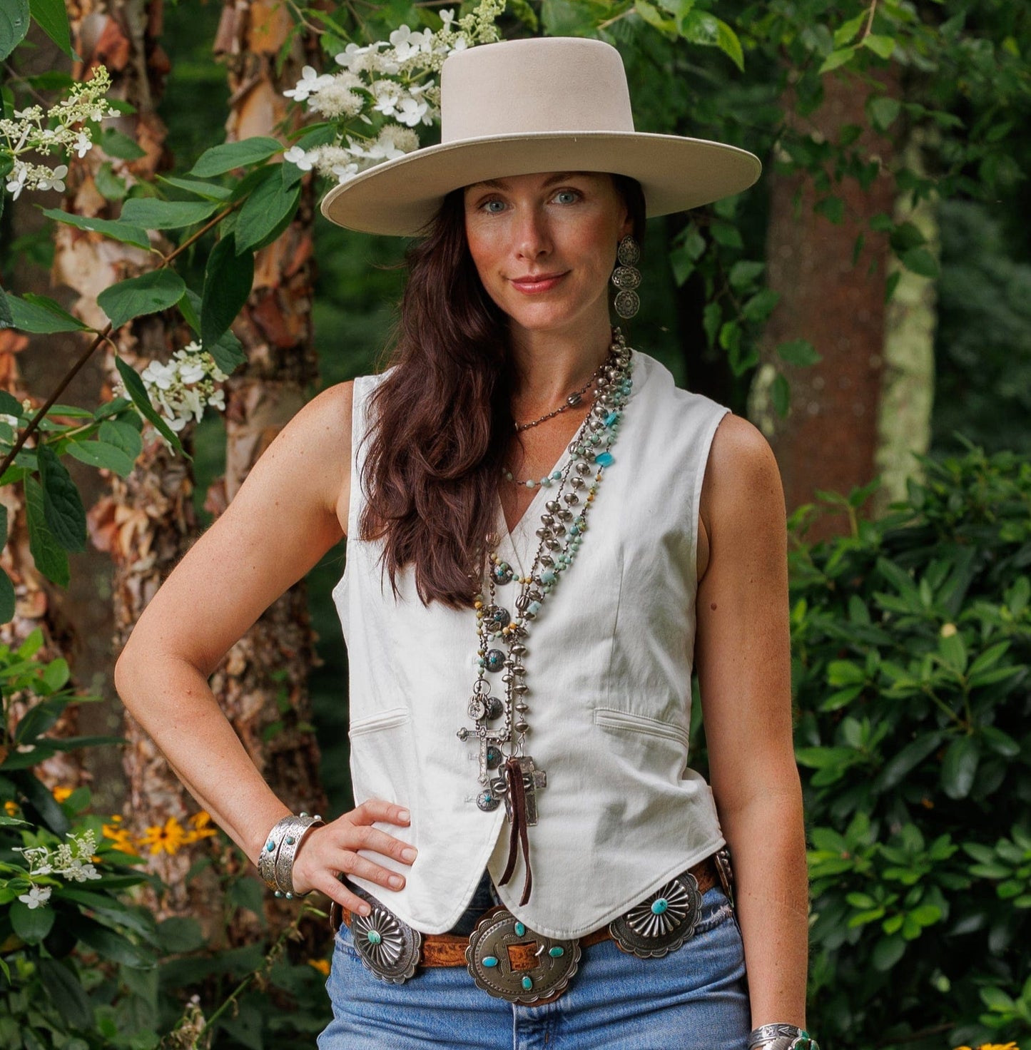 Woman in Lilith Vest, hat, & turquoise jewelry