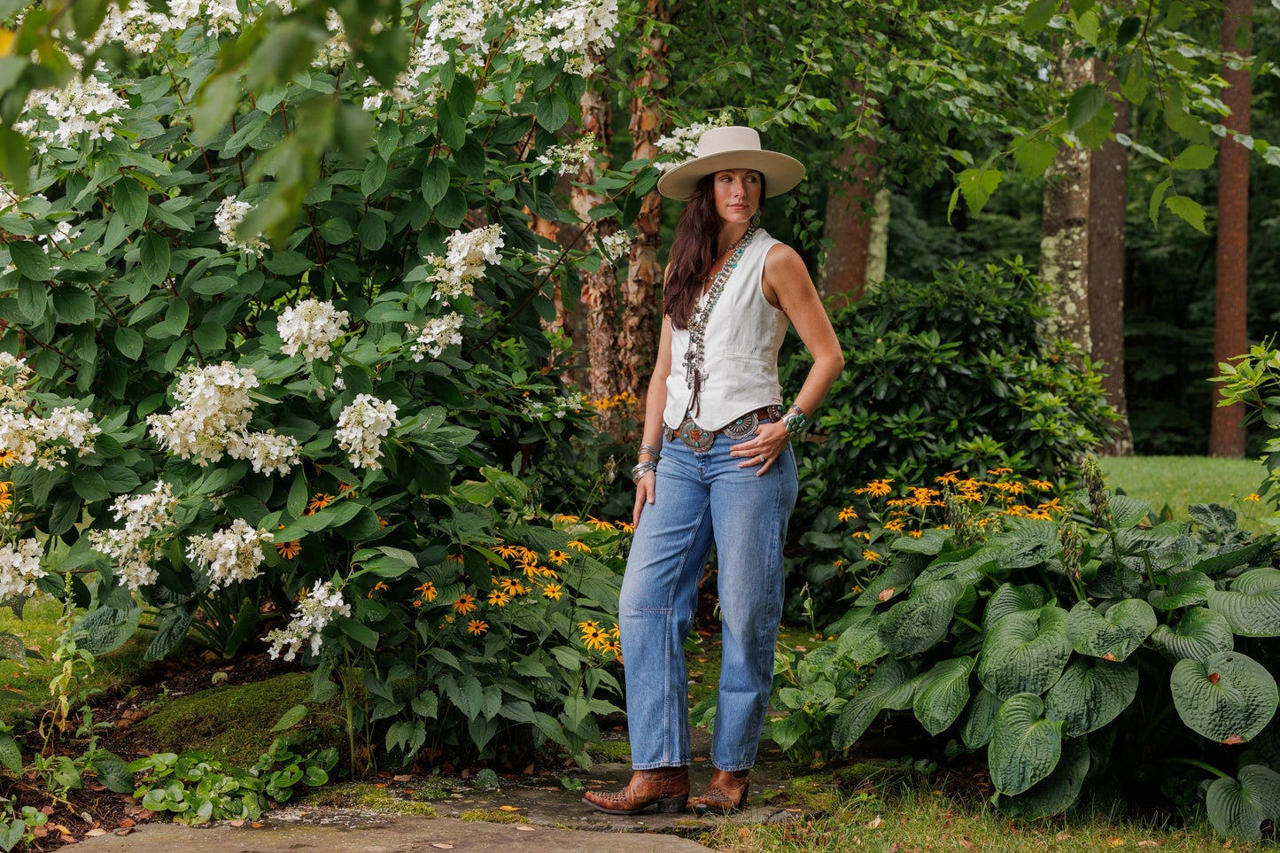 Lilith Vest 03 - Woman in garden wearing vest and jeans