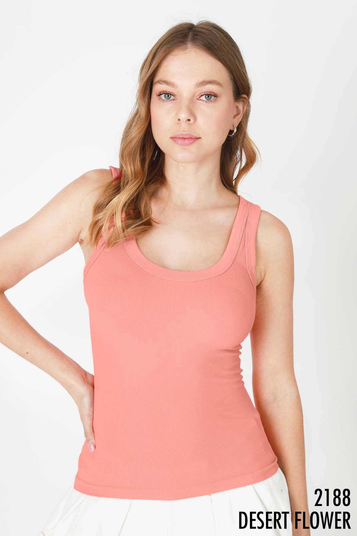 Woman wearing a coral-colored tank top.