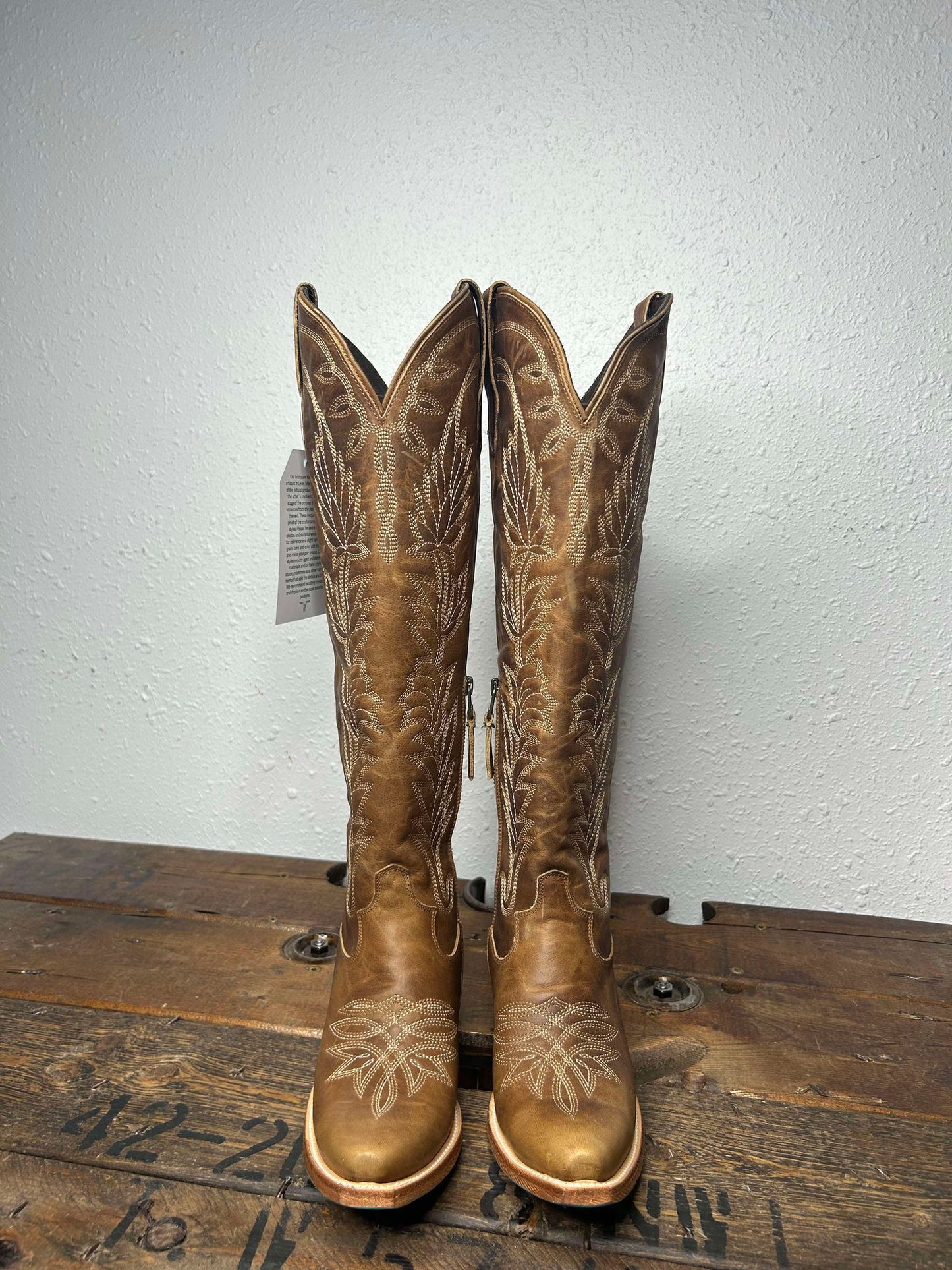 Pair of tall, brown cowboy boots.