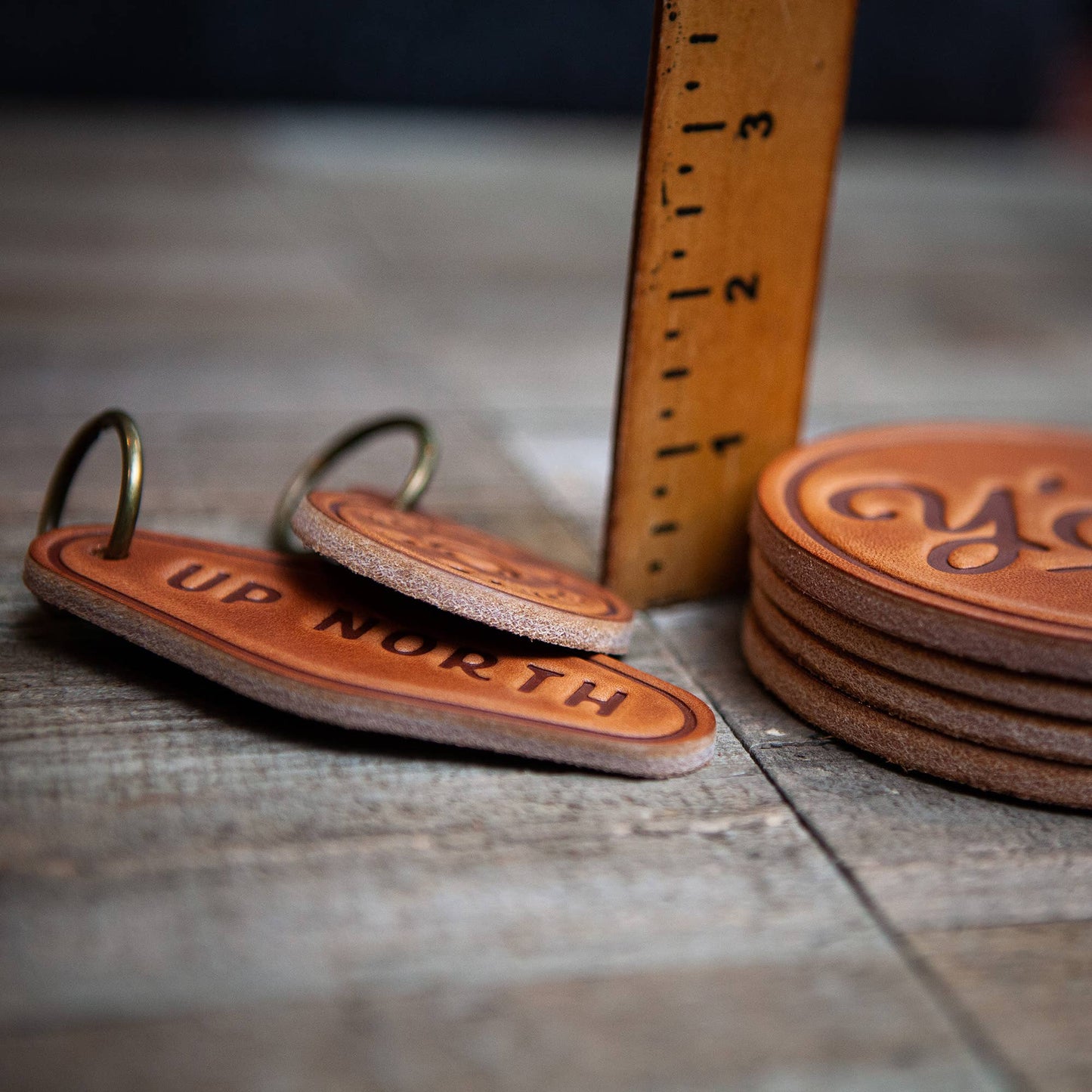 Up North leather keychains and coasters with a ruler