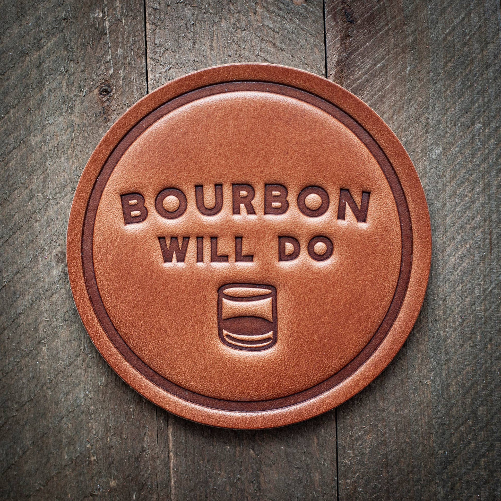 Brown leather coaster with Bourbon Will Do text.