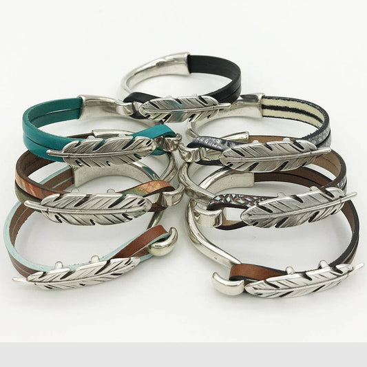 Leather bracelets with silver feather clasps.