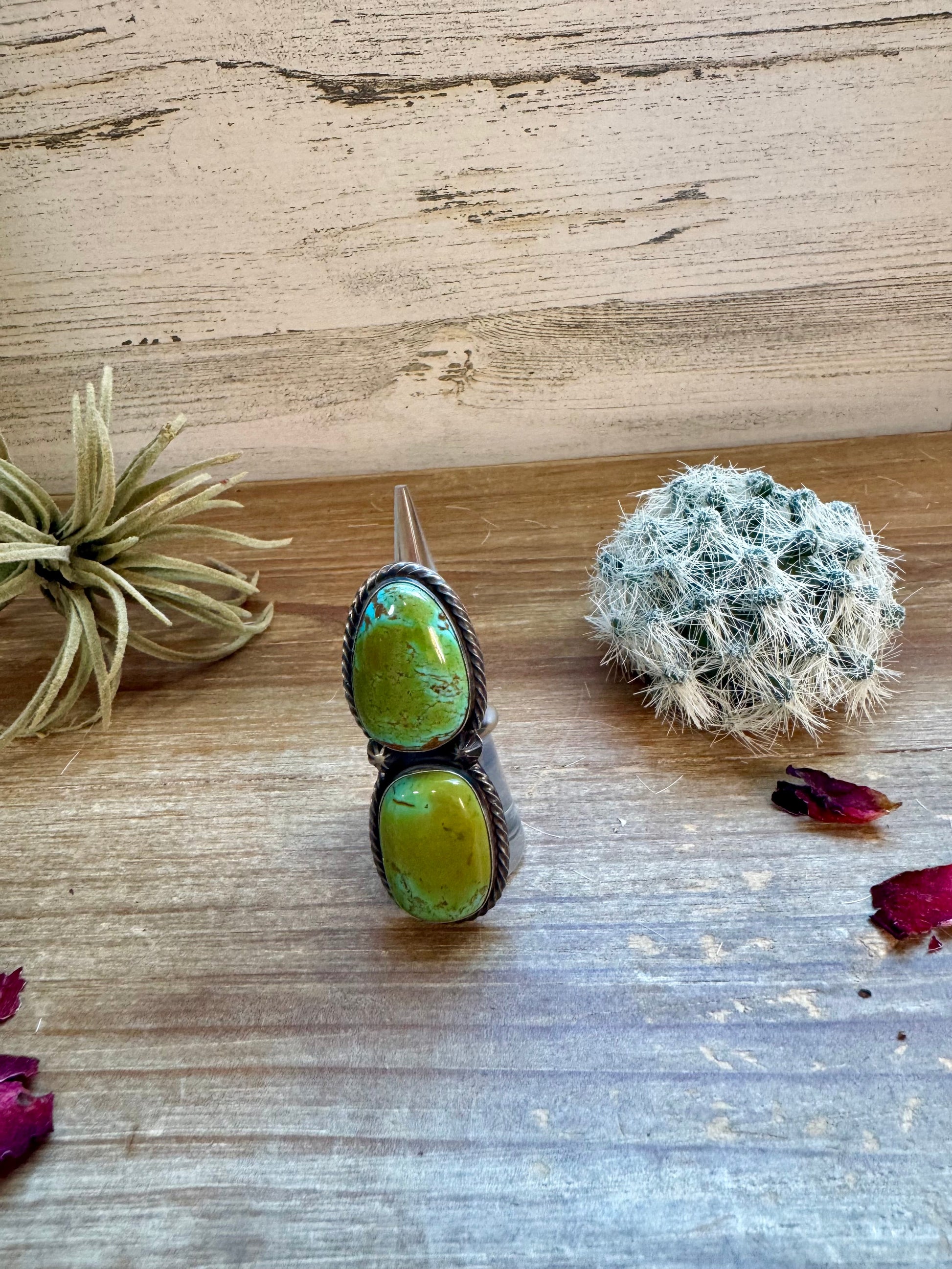 Turquoise ring, 61538FA2-BE71-497C-B2E3-735E17634F89, on wood table.