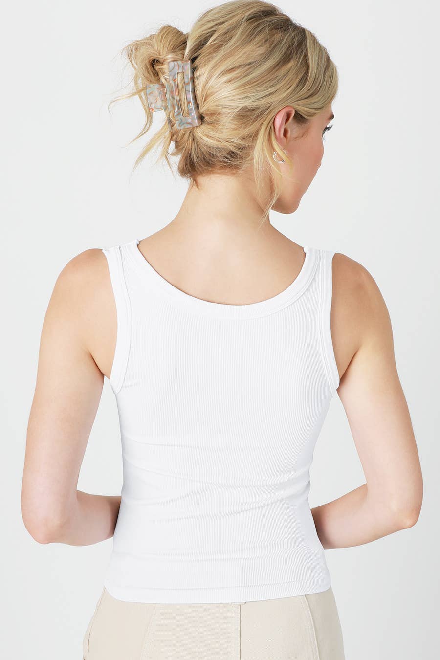 Woman in white tank top from the back.