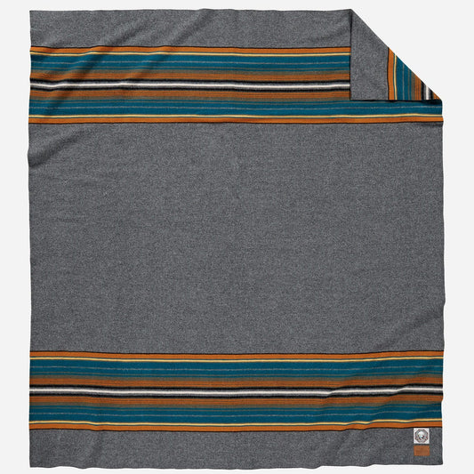 Gray blanket with colorful stripes.