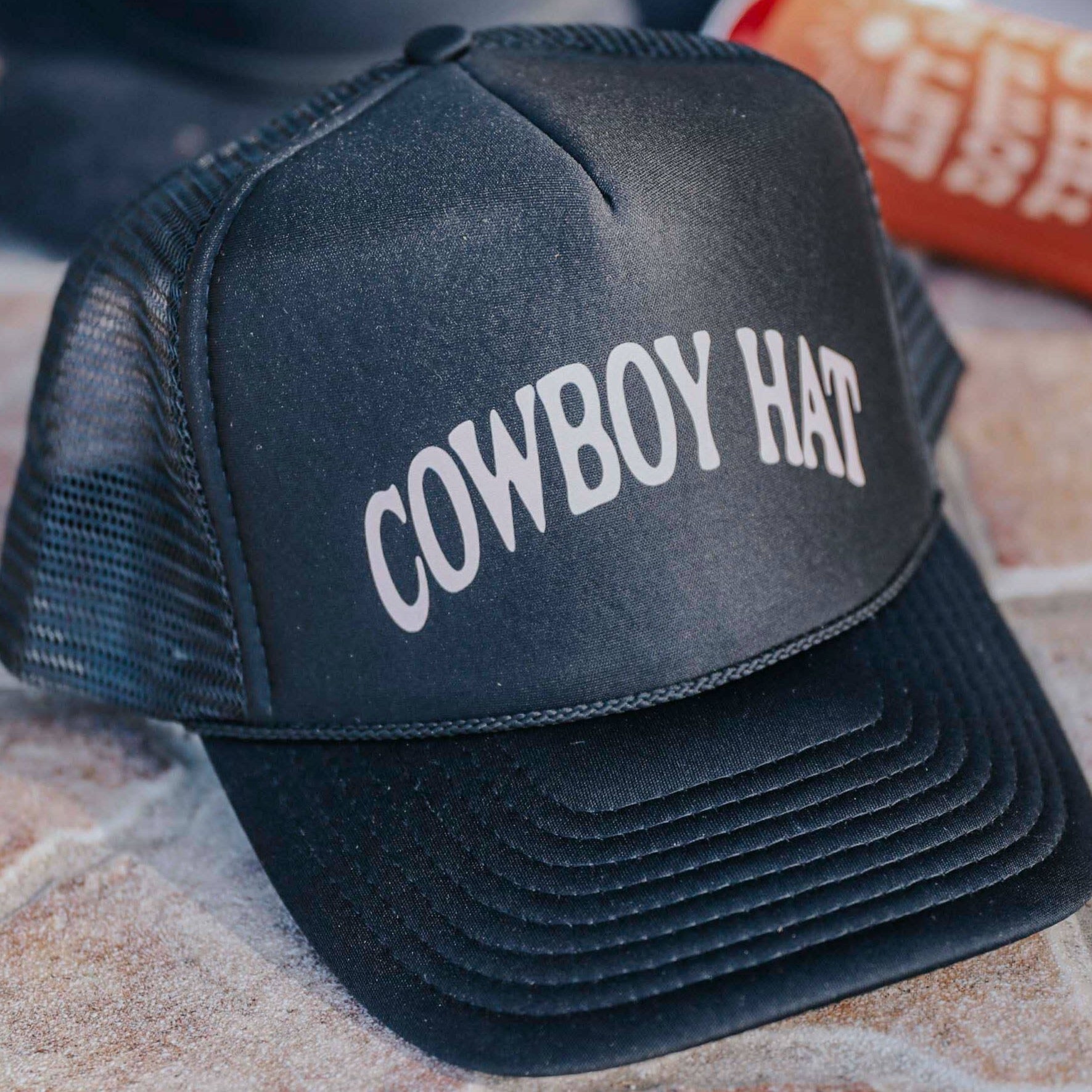 Black trucker hat with COWBOY HAT text.