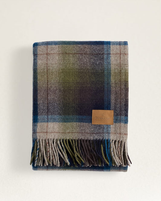 Plaid blanket with fringe and label.