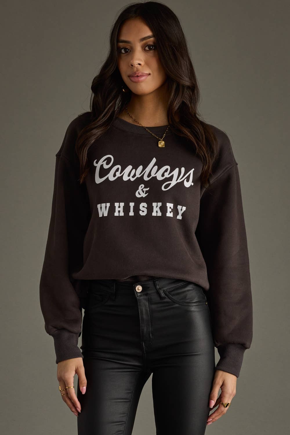 Woman in a sweatshirt that says Cowboys & Whiskey.