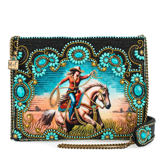 Beaded purse with a painting of a cowboy on a horse.