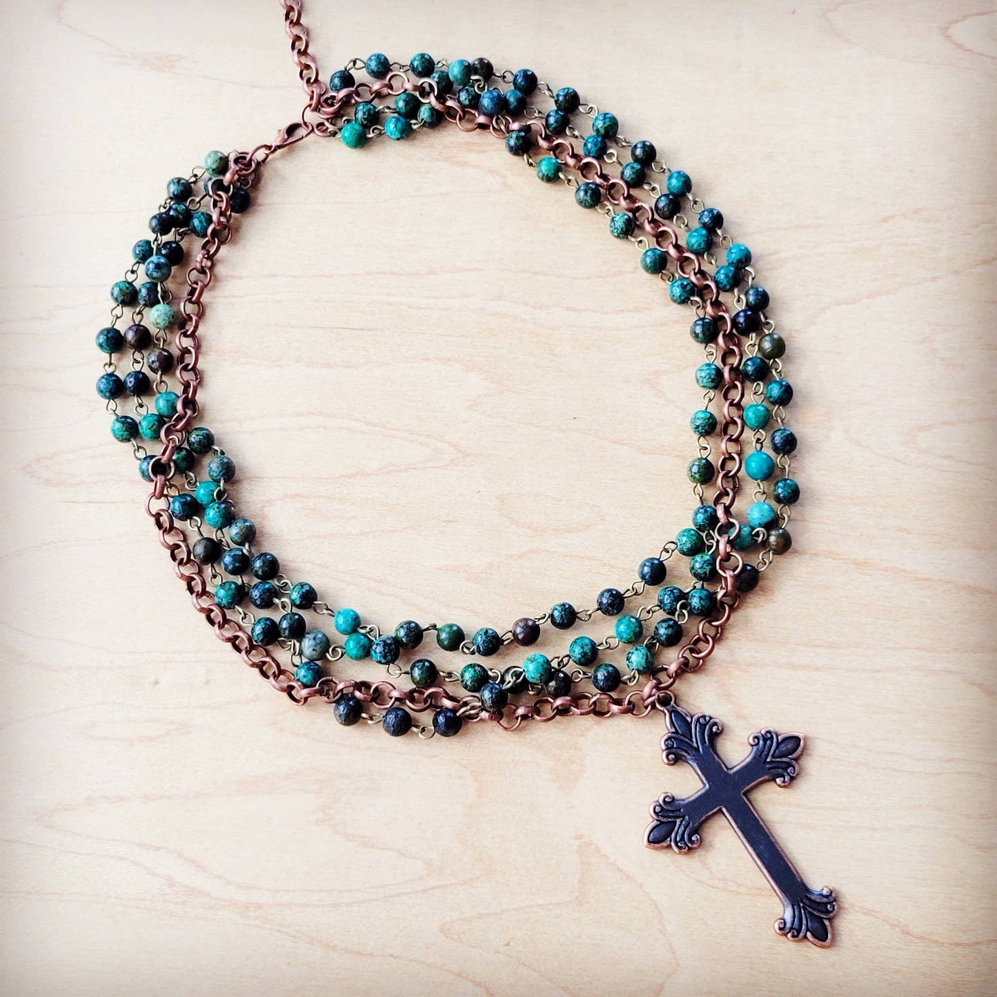 Necklace with turquoise beads and a cross pendant.