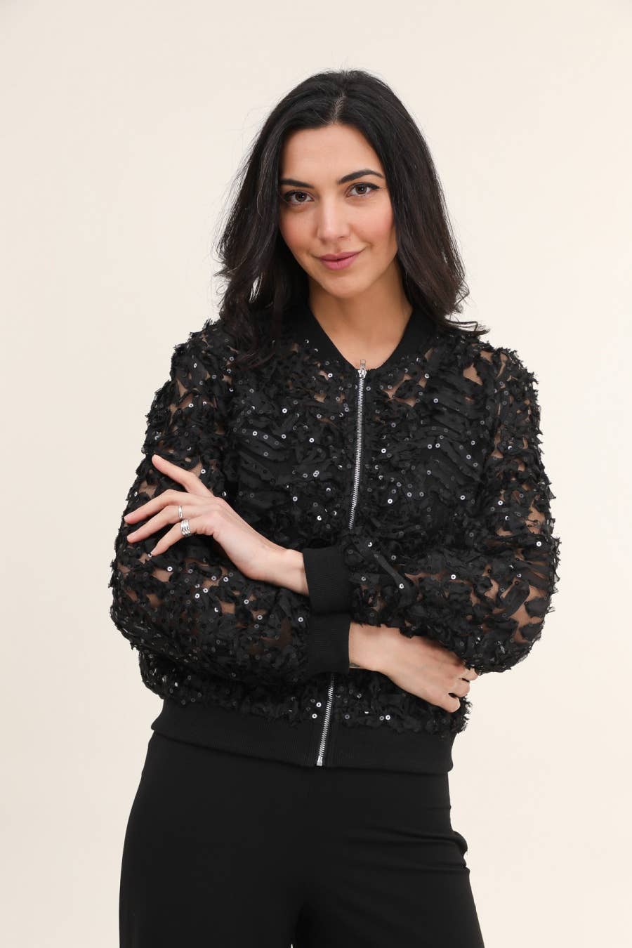 Woman in black sequin bomber jacket.
