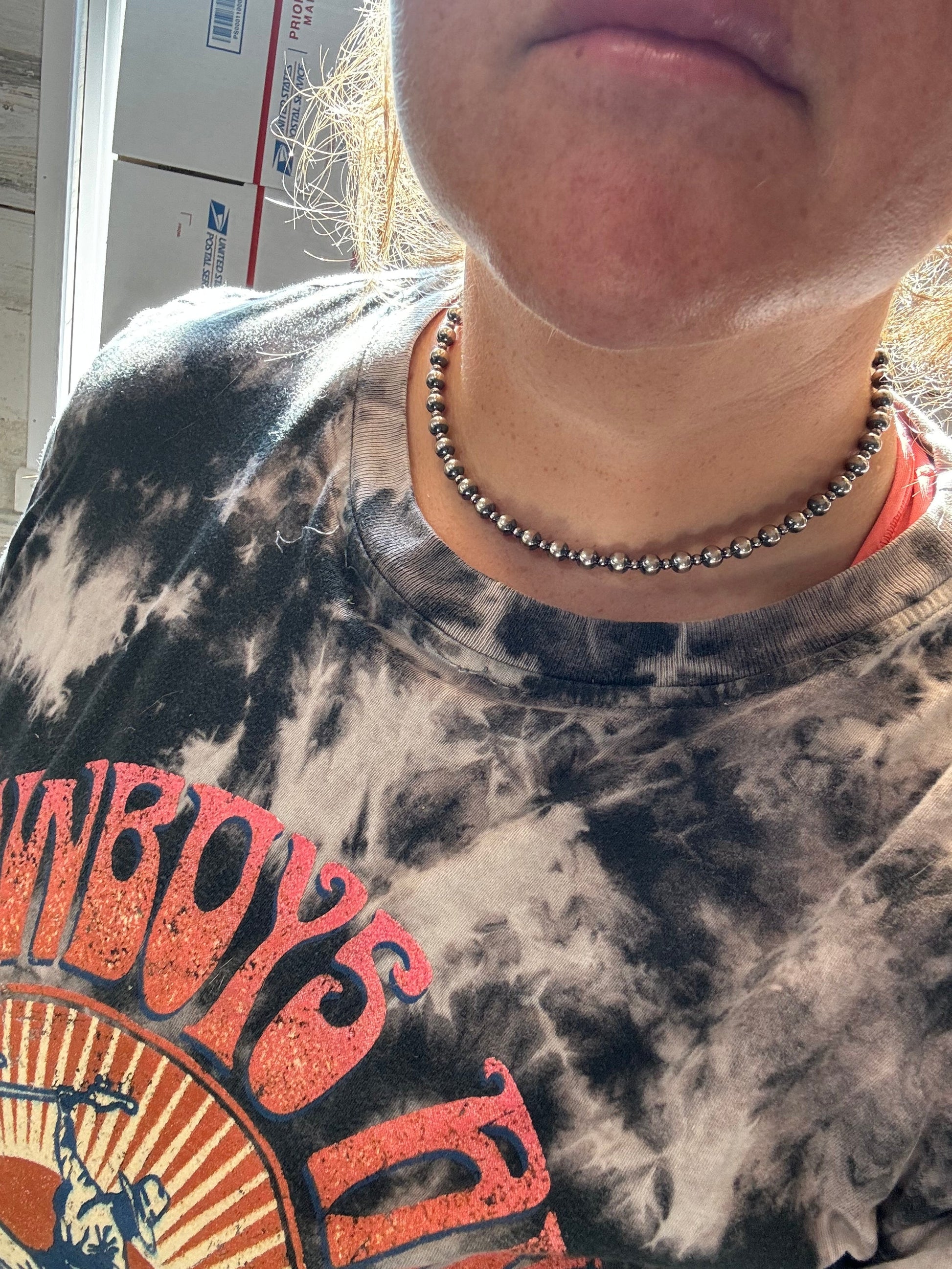 Woman wearing silver bead necklace, image 8970E7A5