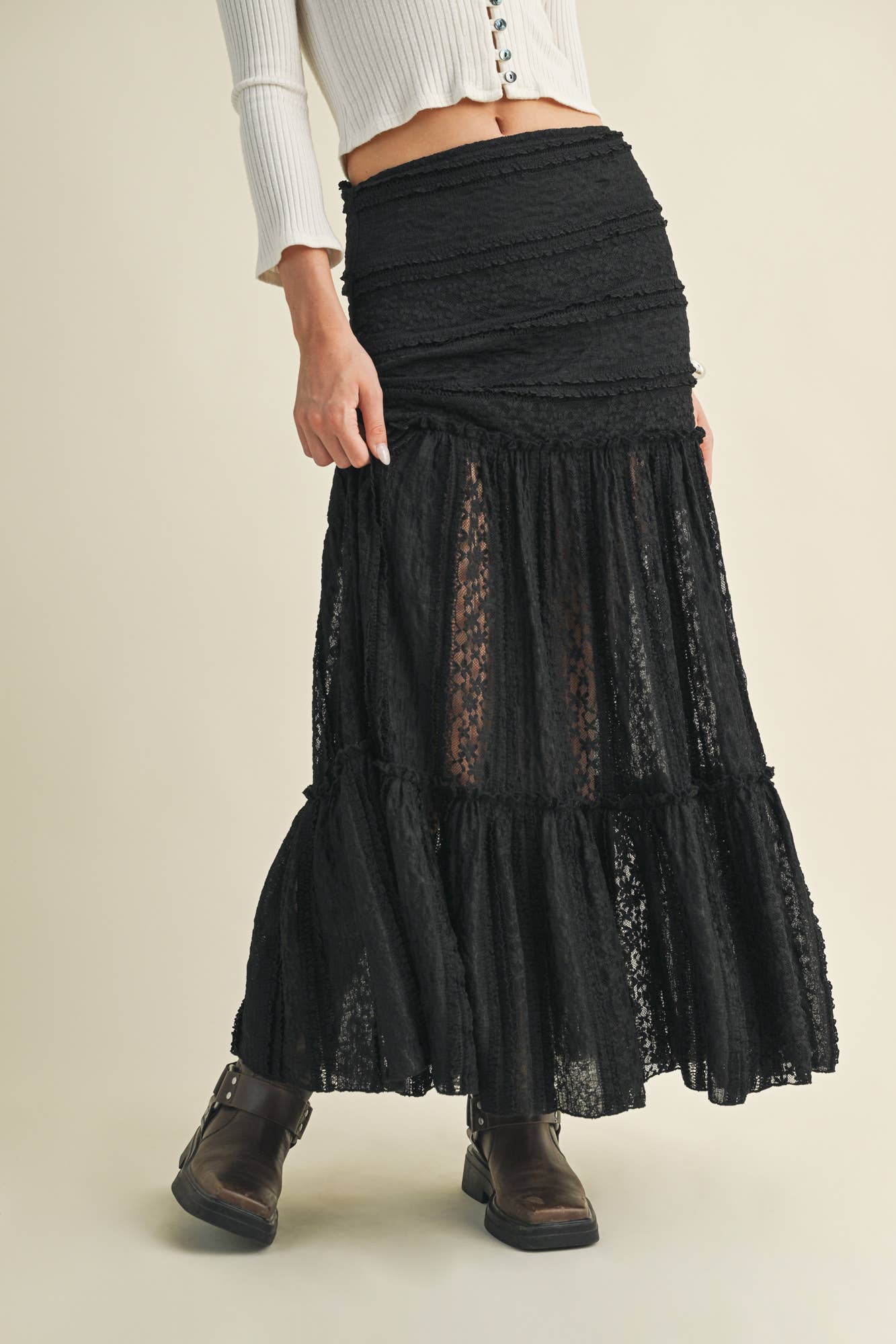 Woman in black lace skirt and boots.