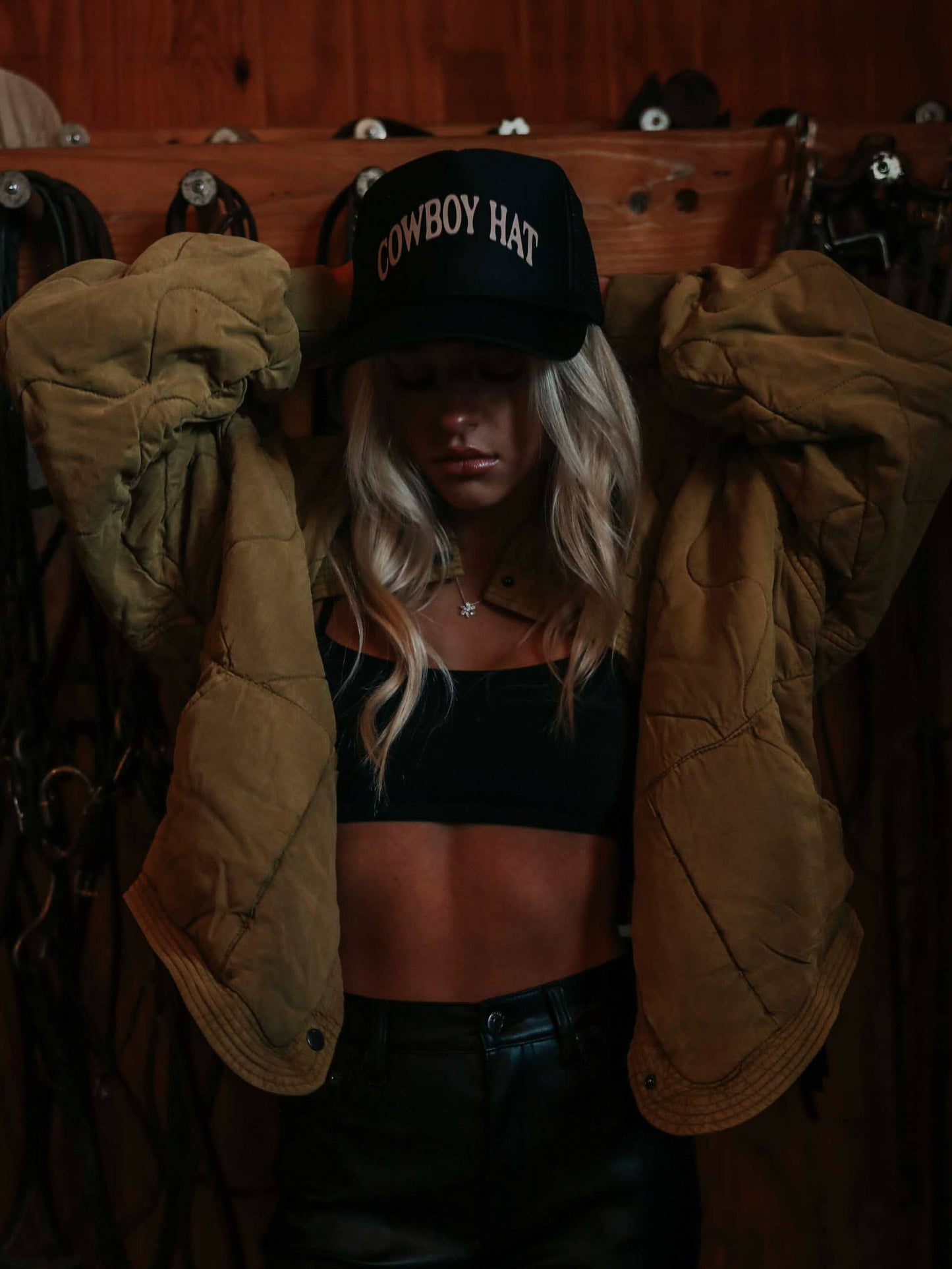 Woman in cowboy hat and jacket.