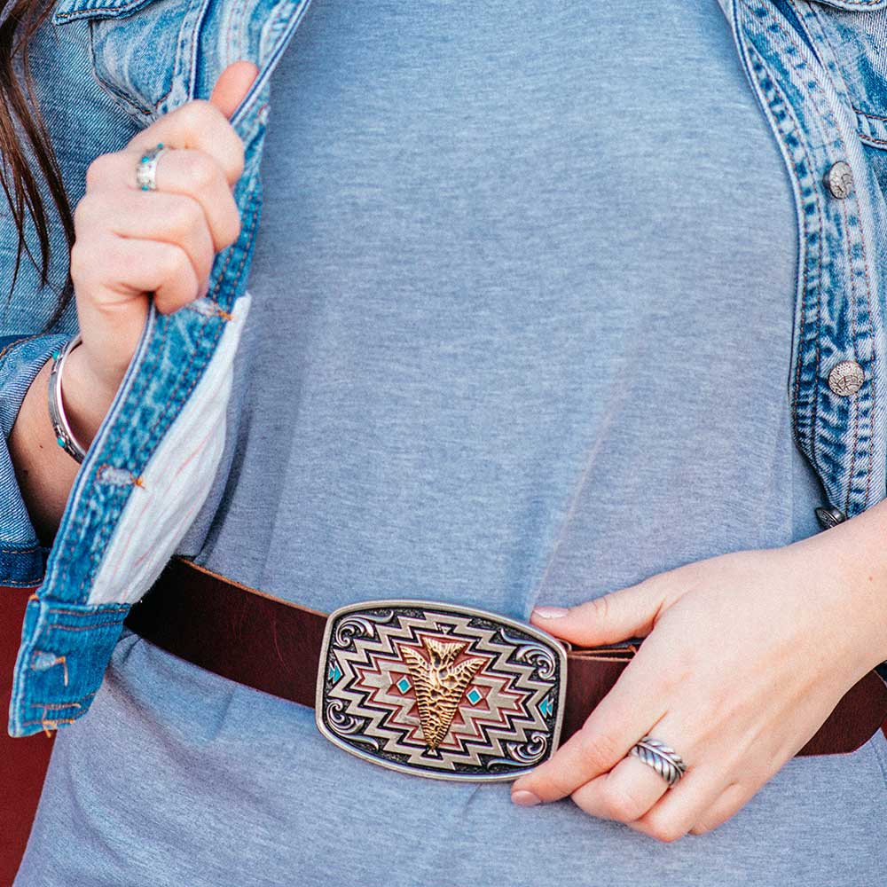 Woman wearing belt with decorative buckle