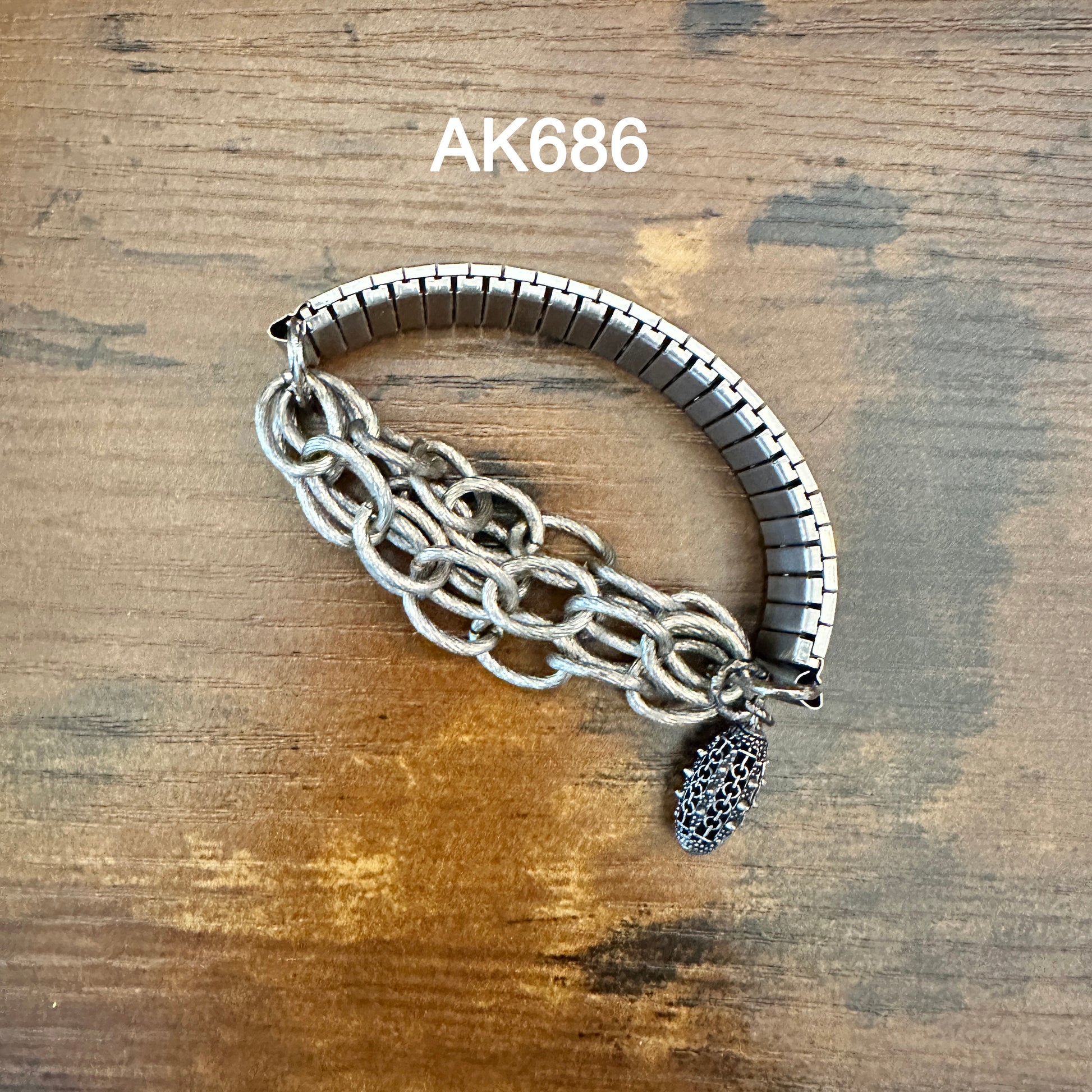 AK686 Silver bracelet with chain and charm on wood