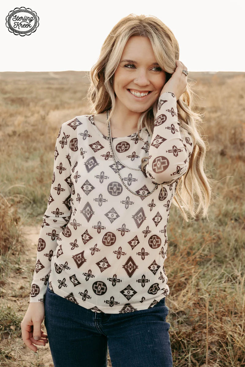 Brown and cream patterned top on woman
