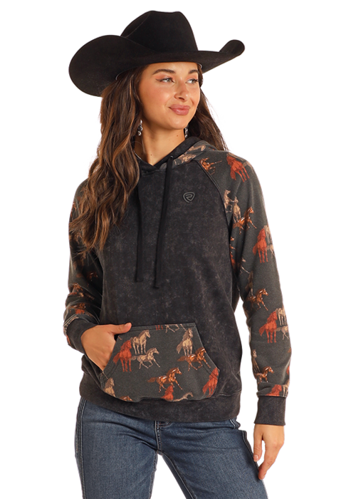Woman wearing a horse print hoodie and cowboy hat.