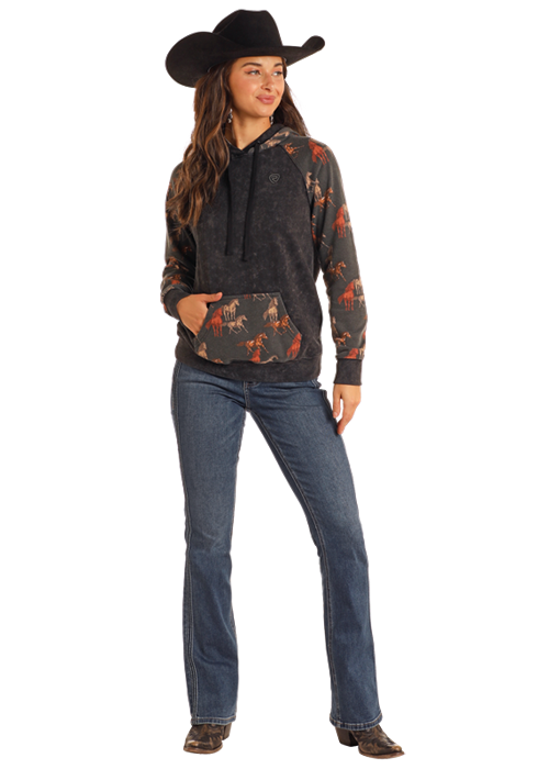 Woman in cowboy hat and horse print hoodie