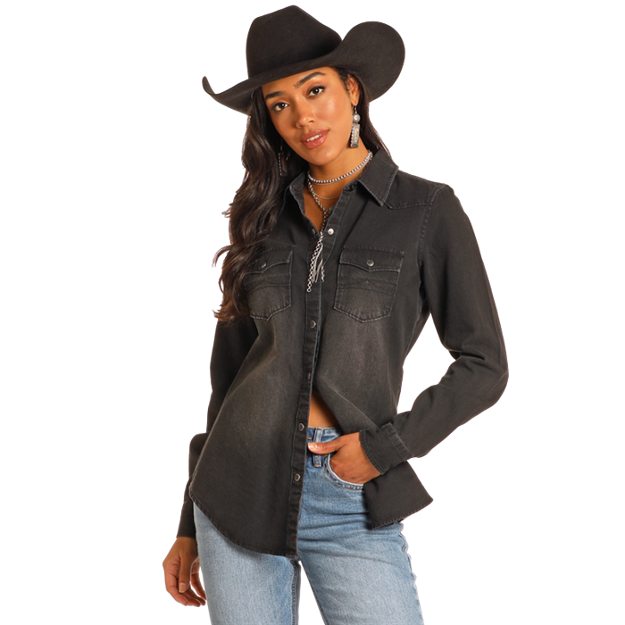 Woman in black denim shirt and cowboy hat