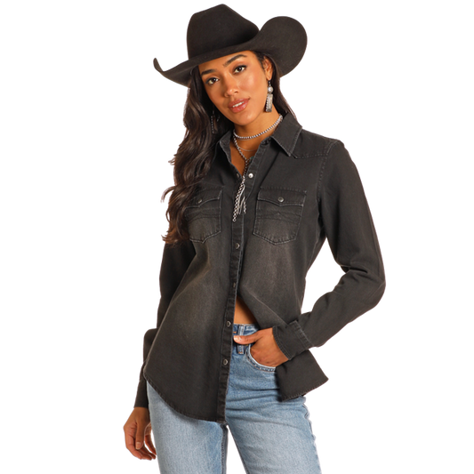Woman in black denim shirt and cowboy hat