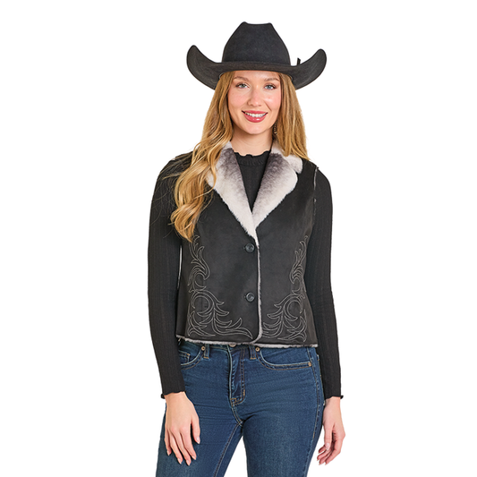 Woman wearing black cowboy vest and hat