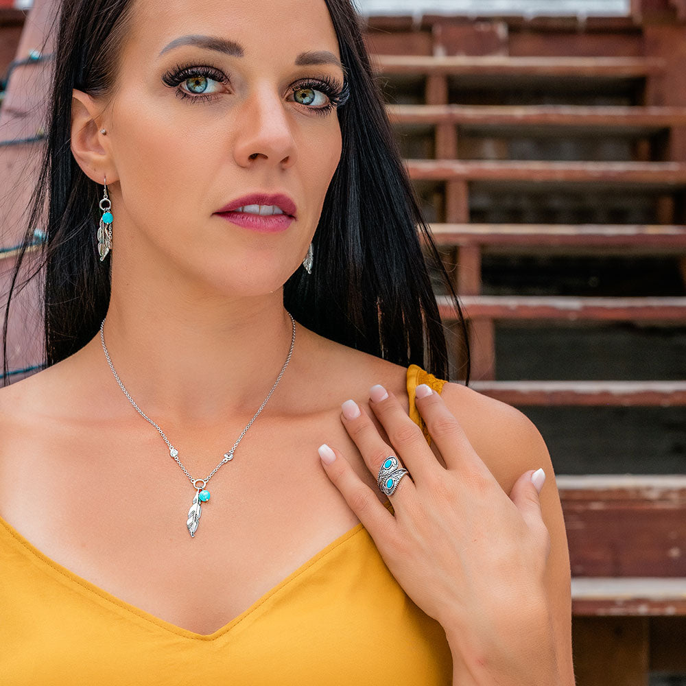Woman wearing turquoise feather jewelry - E-Bynder-RG4753