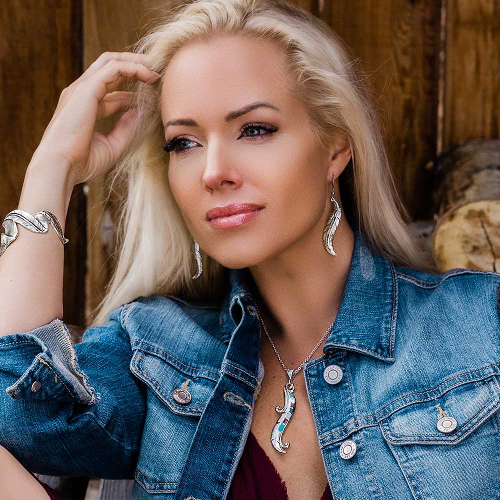 Woman wearing silver jewelry and denim jacket